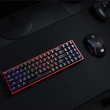 Redragon K628 Pollux 75% Wired RGB Gaming Keyboard and a Redragon mouse on a desk mat, showing the keyboard's vibrant RGB lighting