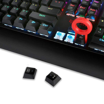 Close-up of Redragon K557 Kala RGB Backlit Wired Gaming Keyboard, revealing blue mechanical switches and a keycap puller