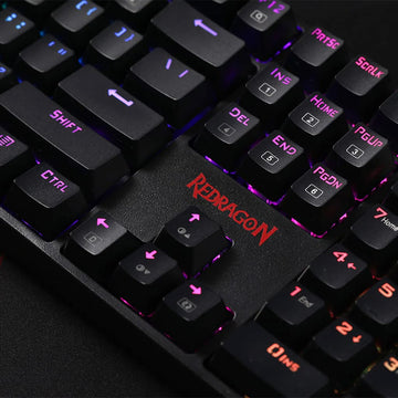 Detailed shot of Redragon K582 Surara keyboard, highlighting the illuminated keys in various RGB colors & textured black keycaps