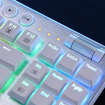 The upper right corner of the white Redragon K621 White Horus wireless keyboard, showing function keys, media controls & indicator lights